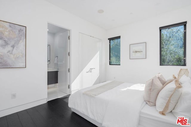 bedroom featuring hardwood / wood-style floors and connected bathroom