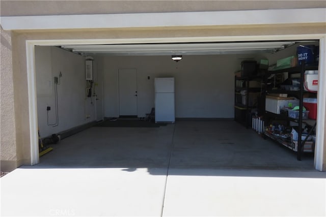 garage with water heater and white fridge