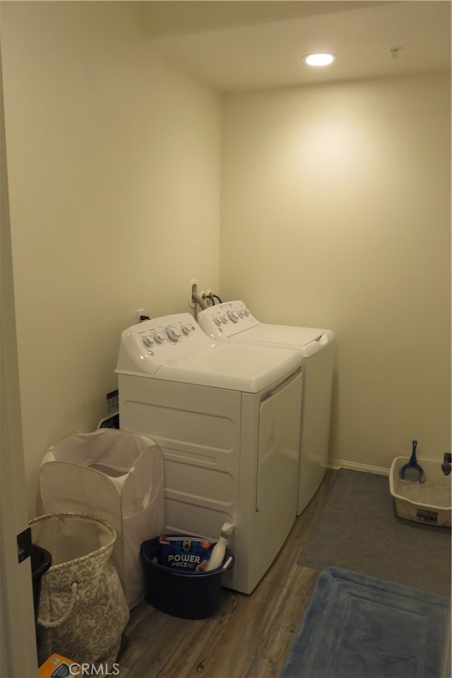 laundry room featuring separate washer and dryer and dark hardwood / wood-style floors