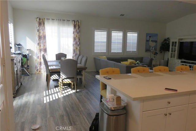 24819 Onyx Dr, Menifee, CA 92585 - kitchen with white cabinetry, wood finished floors, light countertops, and open floor plan