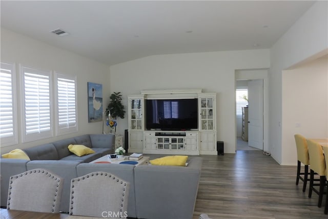 living room with lofted ceiling and dark hardwood / wood-style flooring