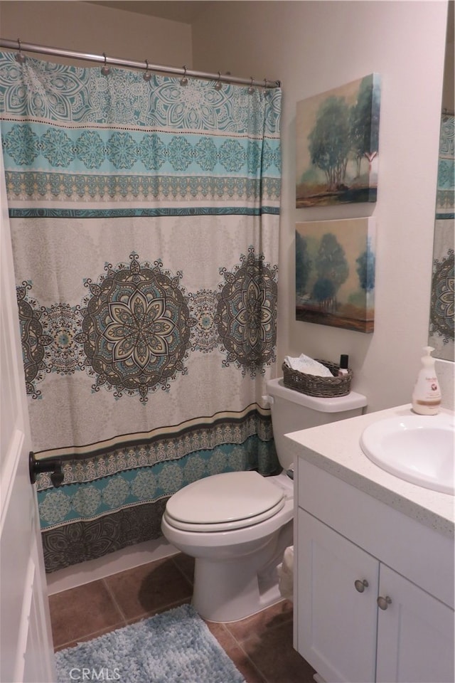 bathroom featuring vanity, toilet, and tile patterned flooring