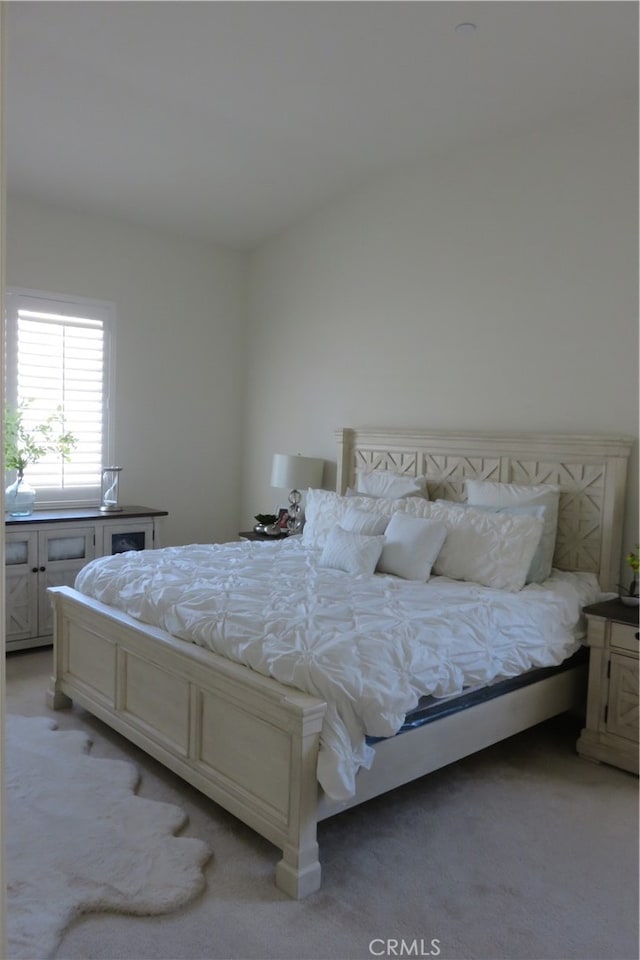 bedroom featuring light colored carpet