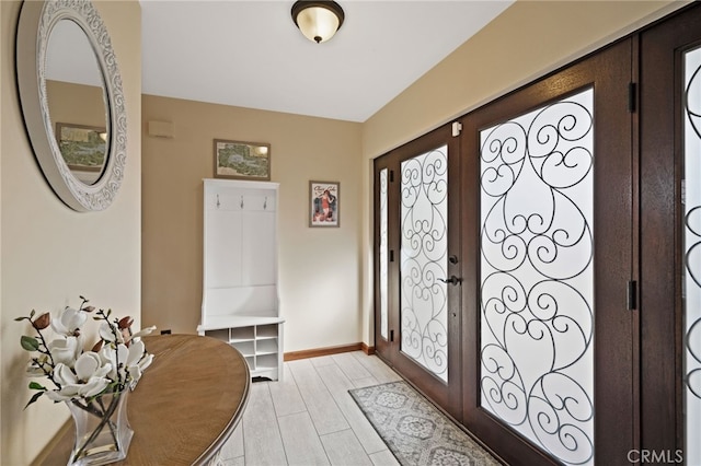 foyer entrance featuring french doors and light wood-type flooring