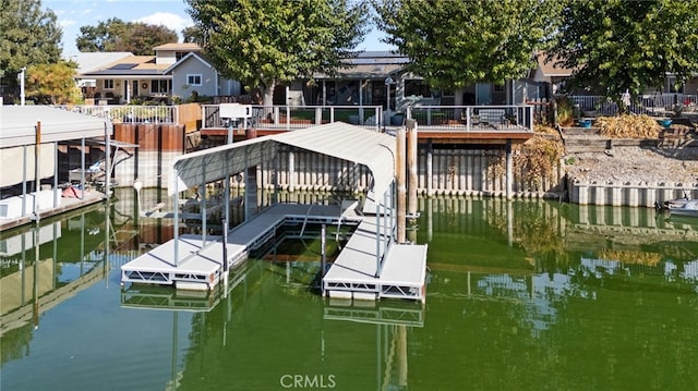 dock area featuring a deck with water view