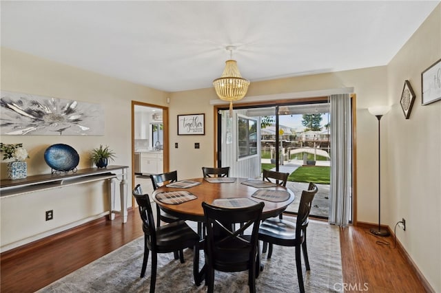 dining room featuring hardwood / wood-style flooring and an inviting chandelier