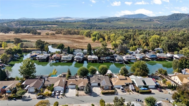 drone / aerial view with a water and mountain view