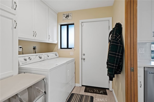 laundry area featuring independent washer and dryer and cabinets