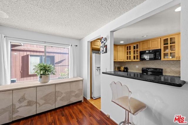 kitchen with black appliances, decorative backsplash, dark hardwood / wood-style flooring, and a textured ceiling