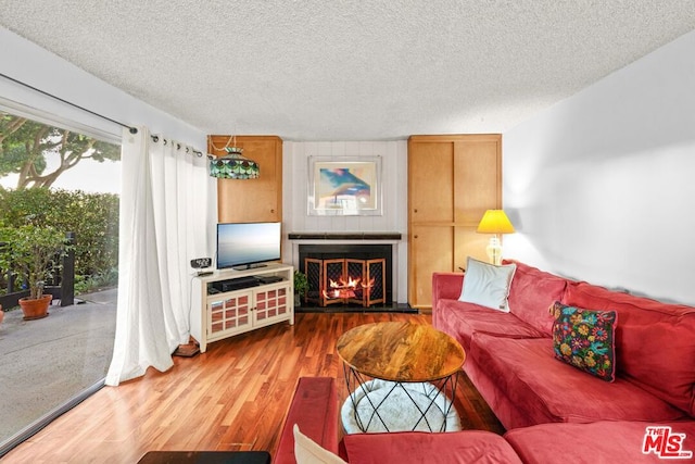 living room with hardwood / wood-style floors and a textured ceiling