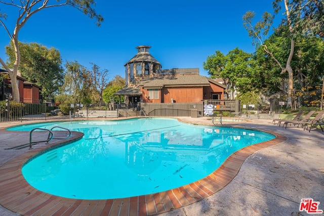 view of swimming pool with a patio area