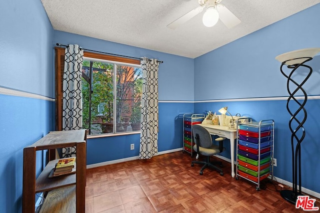 home office featuring ceiling fan, parquet floors, and a textured ceiling