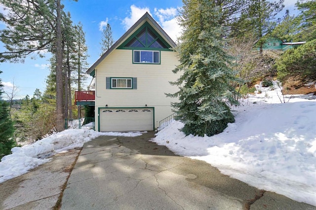 view of snow covered exterior featuring a garage