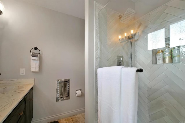 bathroom featuring vanity and tiled shower