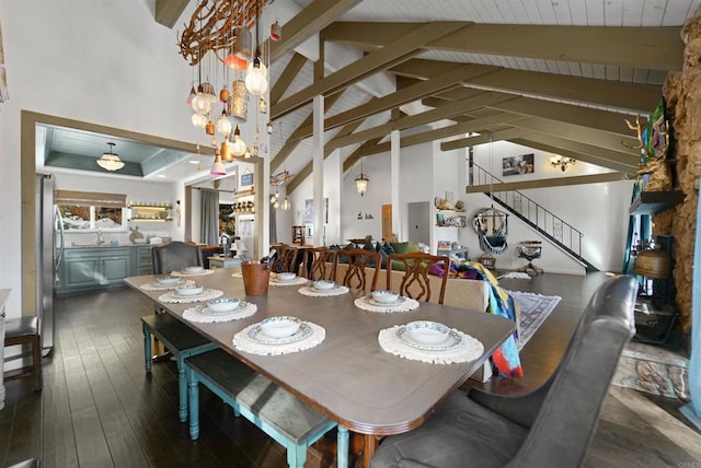 dining room featuring sink, beam ceiling, high vaulted ceiling, and dark hardwood / wood-style flooring