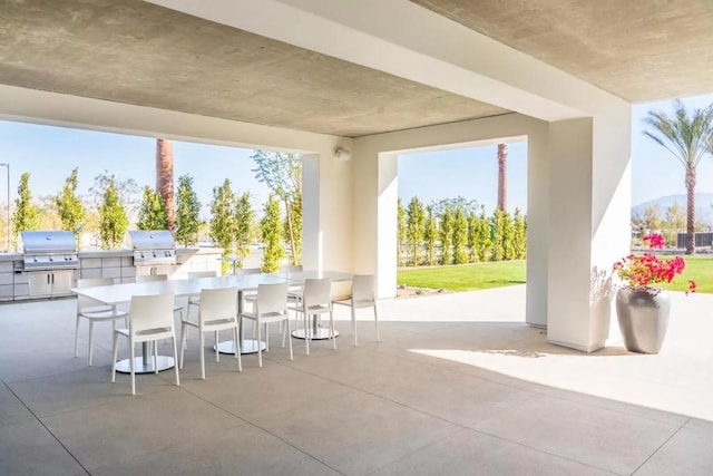 view of patio with exterior kitchen, area for grilling, and an outdoor bar