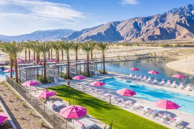 view of home's community featuring a water and mountain view and a swimming pool