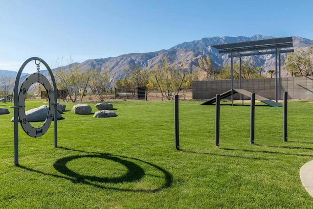 view of property's community with a mountain view and a lawn