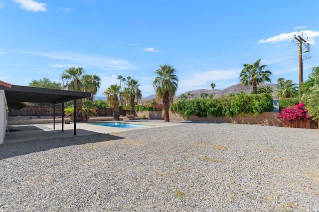 exterior space with a mountain view and a patio