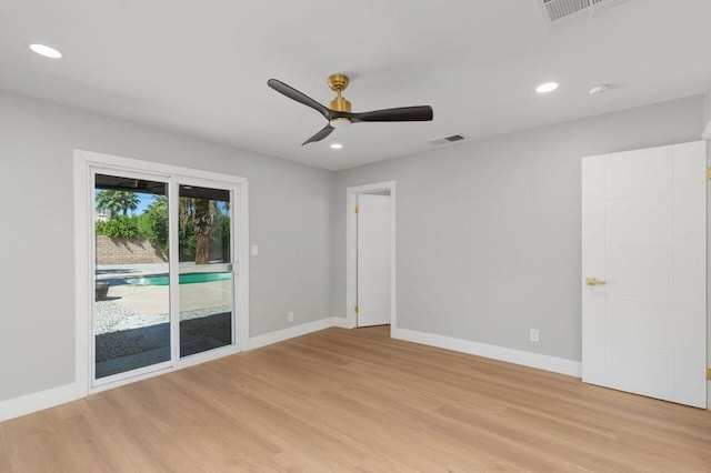 spare room with light wood-type flooring and ceiling fan