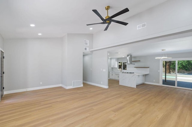 unfurnished living room with light hardwood / wood-style flooring, high vaulted ceiling, and ceiling fan