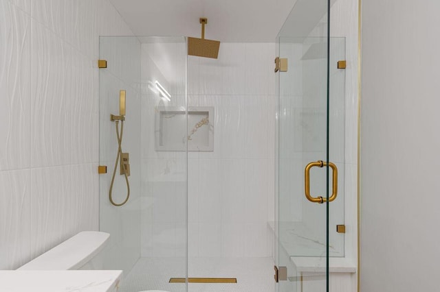 bathroom with toilet and a shower with shower door