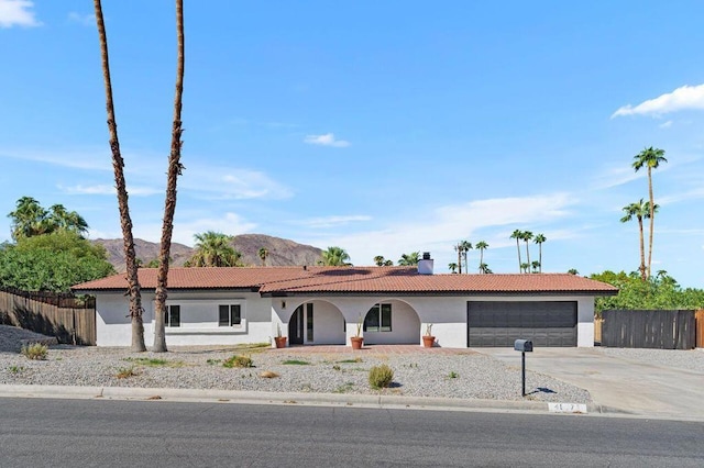 view of front of house featuring a garage and a mountain view