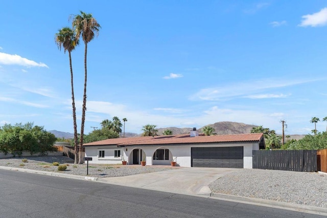 single story home featuring a garage and a mountain view