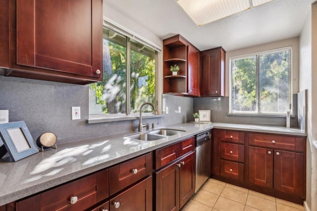 kitchen featuring dishwasher, light stone countertops, sink, and backsplash