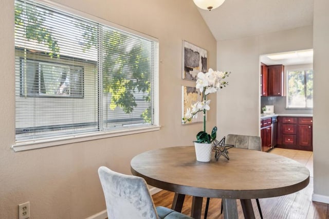 dining area featuring vaulted ceiling and a wealth of natural light