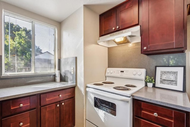 kitchen with light stone counters and electric stove