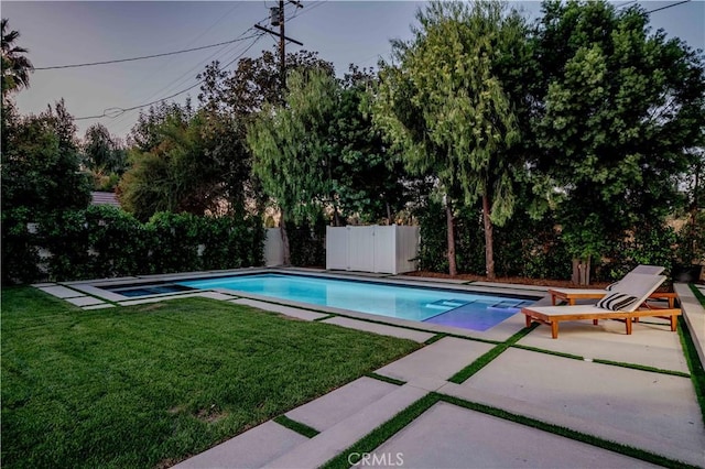 view of pool featuring a patio and a lawn