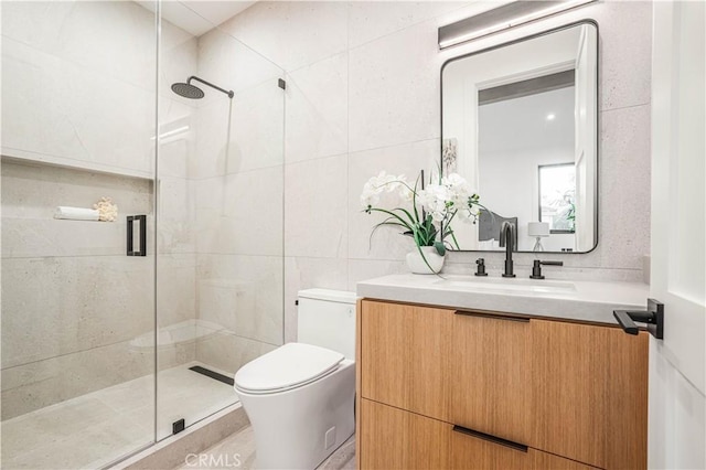 bathroom featuring an enclosed shower, vanity, toilet, and tile walls