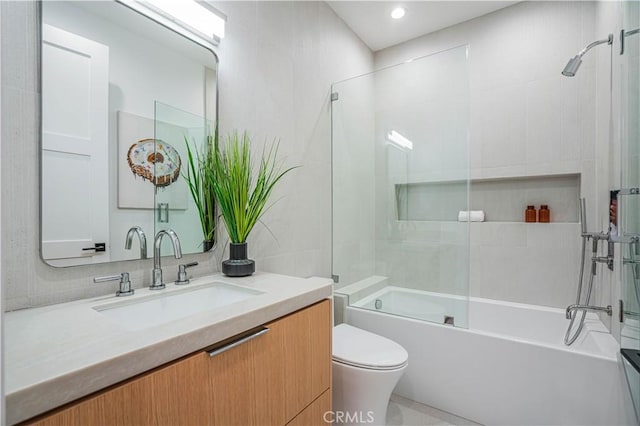 full bathroom featuring vanity, tasteful backsplash, toilet, and bath / shower combo with glass door