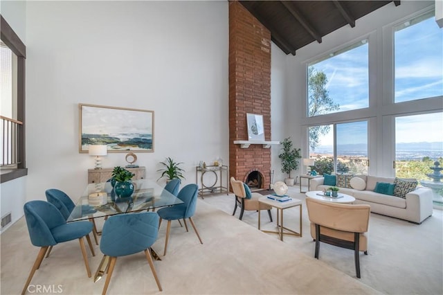 sunroom featuring lofted ceiling with beams, a brick fireplace, and wooden ceiling