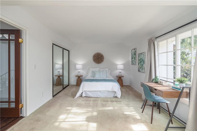 bedroom featuring light colored carpet