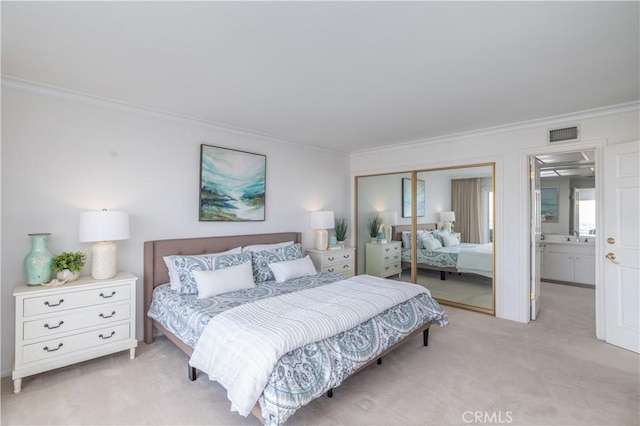 bedroom with light carpet, ornamental molding, and a closet