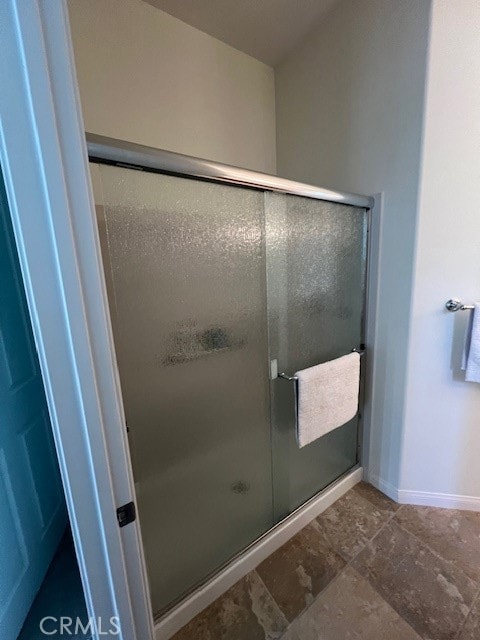 bathroom with a shower with shower door