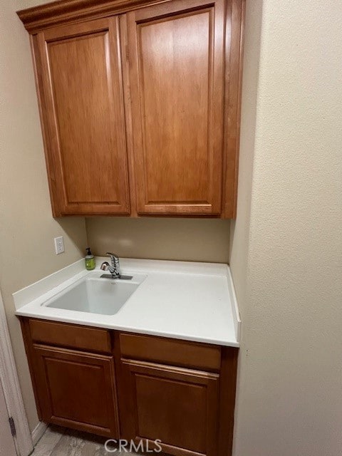 clothes washing area featuring sink