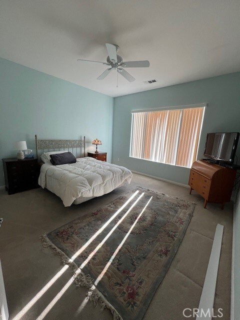 bedroom with ceiling fan and carpet