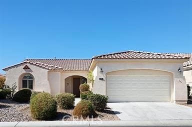 mediterranean / spanish-style house with a garage