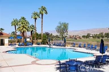 view of swimming pool featuring a mountain view and a patio area