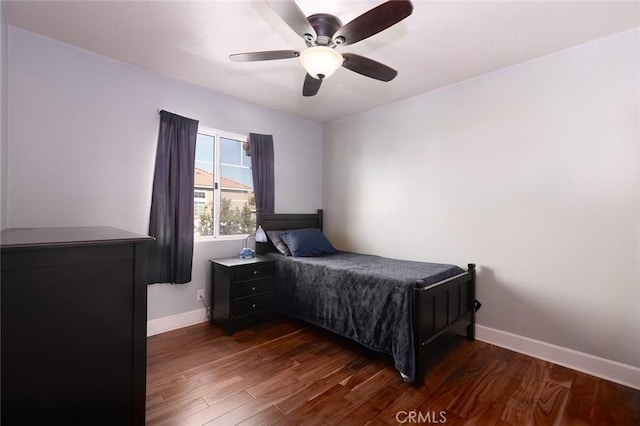 bedroom featuring ceiling fan and dark wood-type flooring