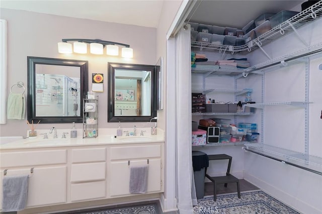 bathroom featuring tile patterned flooring and vanity