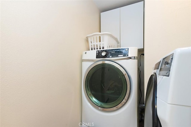 laundry area featuring cabinets and washing machine and dryer