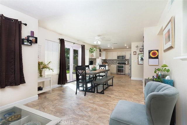 dining space featuring ceiling fan and french doors