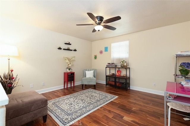 sitting room featuring ceiling fan and dark wood-type flooring