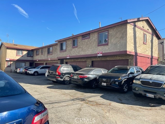 view of vehicle parking featuring a garage