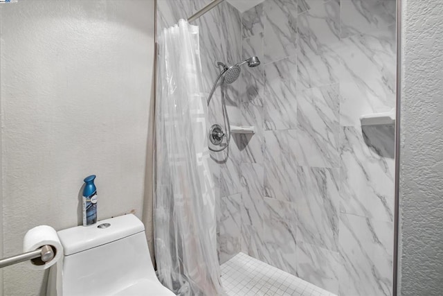 bathroom featuring a shower with shower curtain and toilet