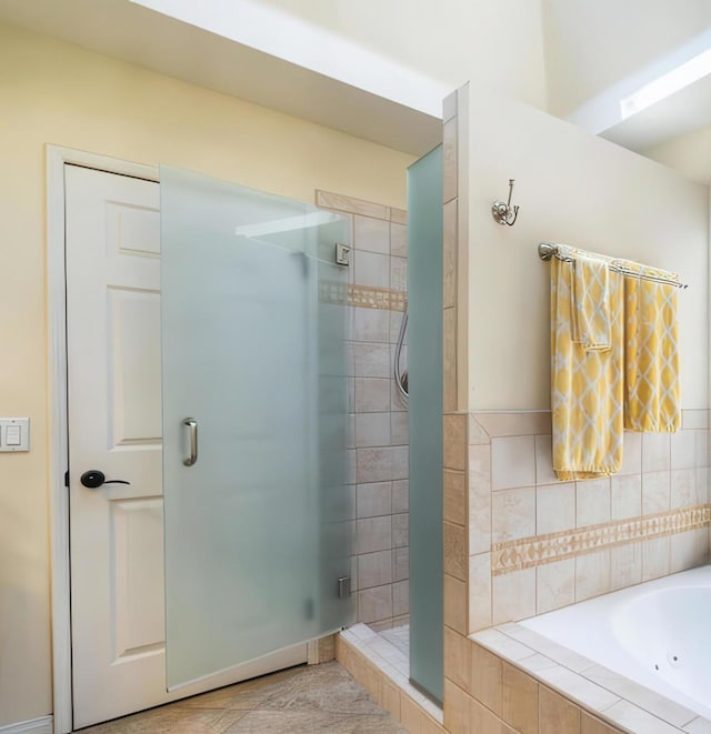 bathroom featuring separate shower and tub and tile patterned flooring